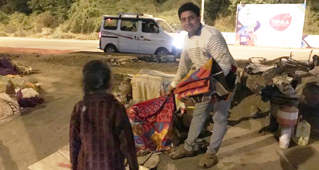 employees distributing blankets to the underprivileged in a community outreach
