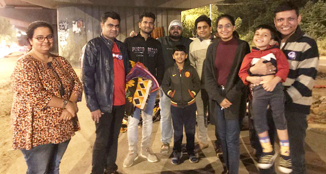 employees distributing blankets to the underprivileged in a community outreach