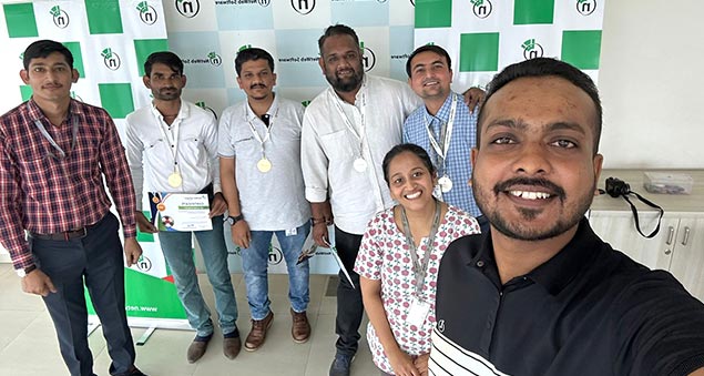 team members playing competitive indoor carrom tournament in 2022