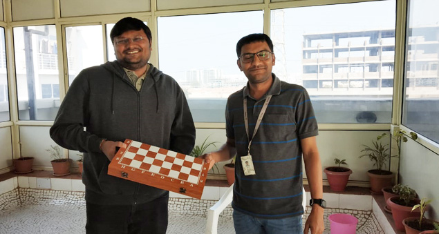 employees participating in a chess tournament promoting strategy and focus