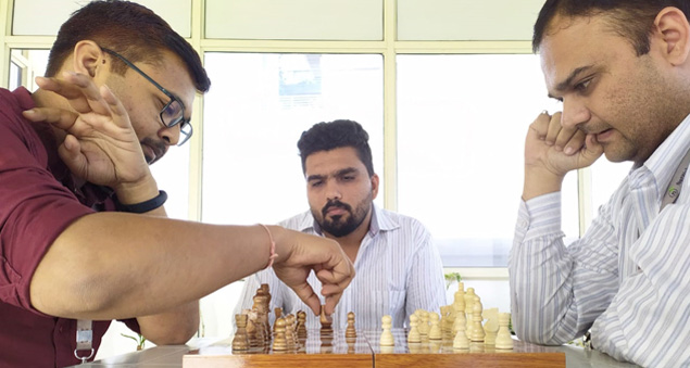 employees participating in a chess tournament promoting strategy and focus