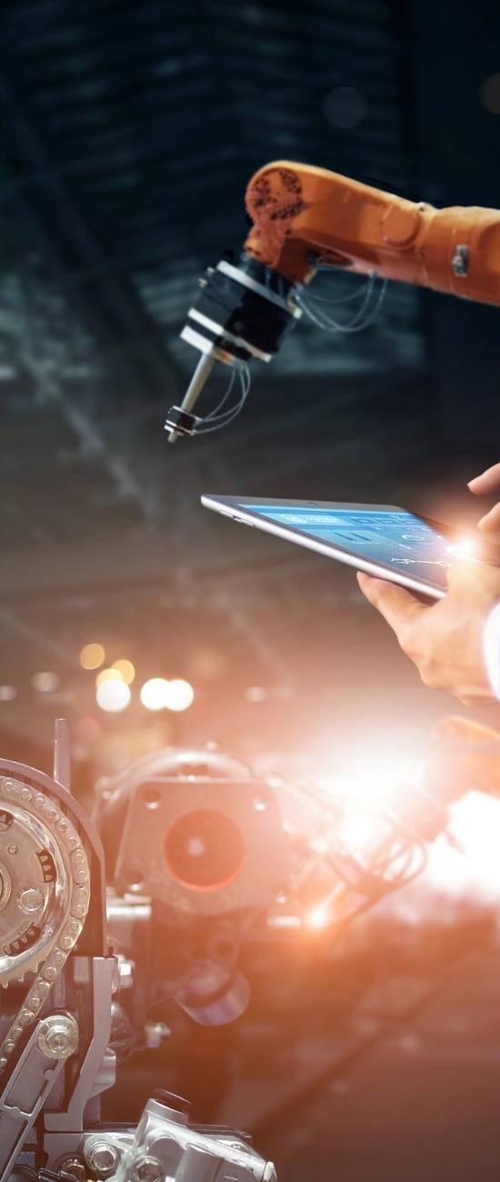 Engineers inspecting automated machinery in a factory